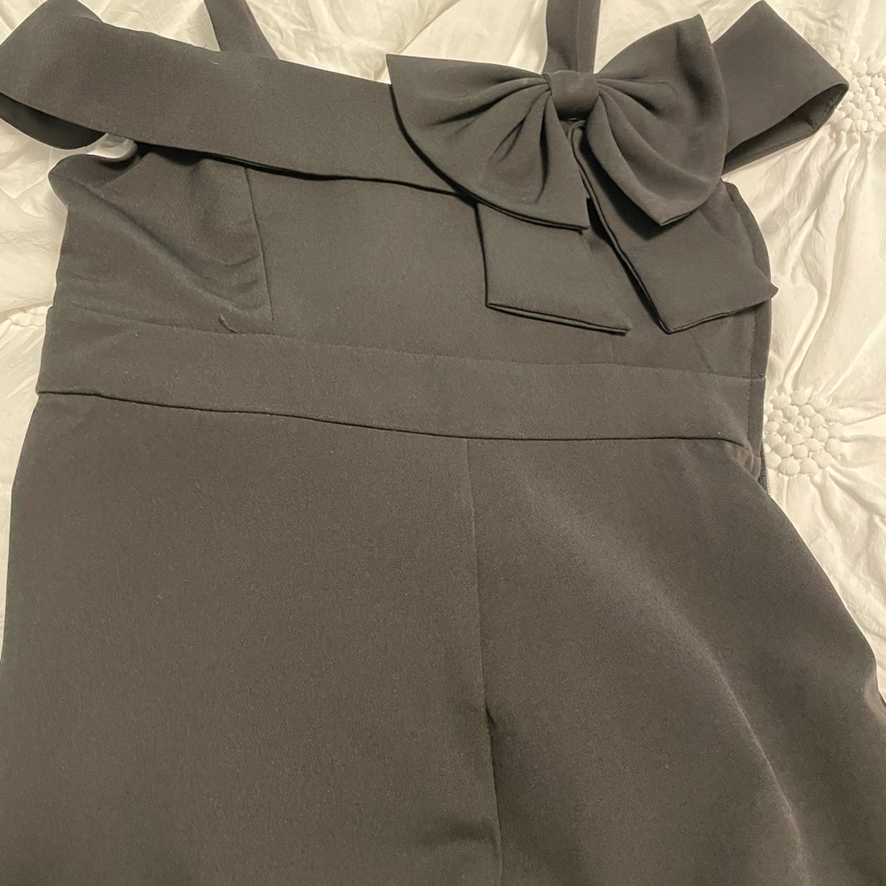 Girls size 8 jumpsuit in black with bow detailing